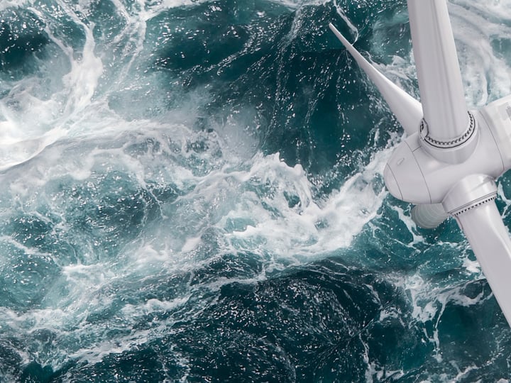 Ocean crashing in to wind turbine